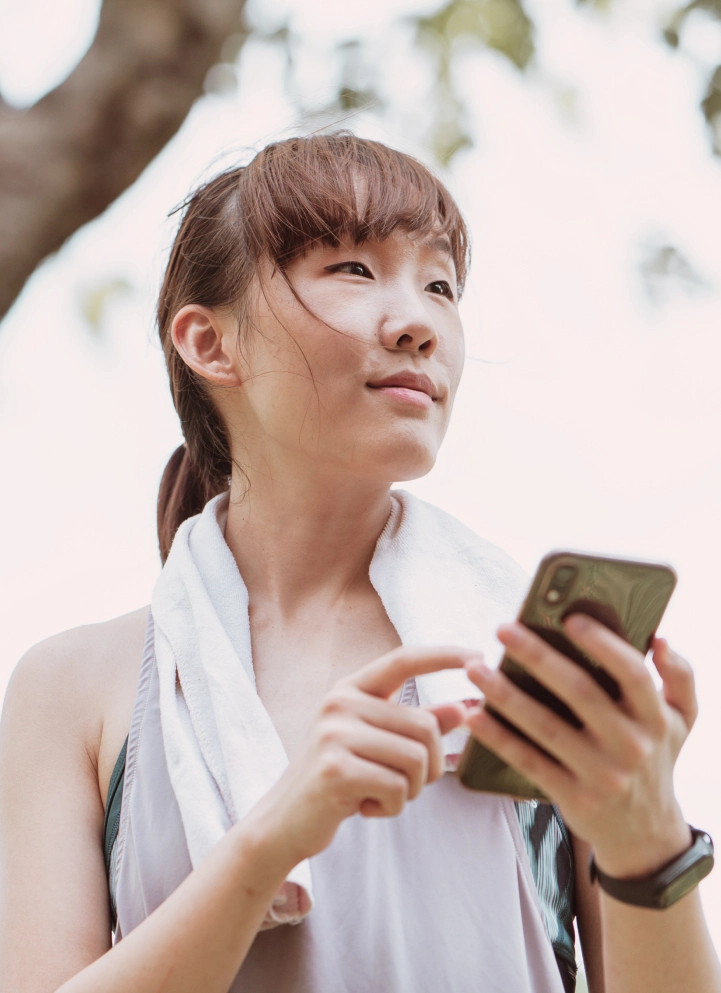 a woman holding a cell phone in her hand